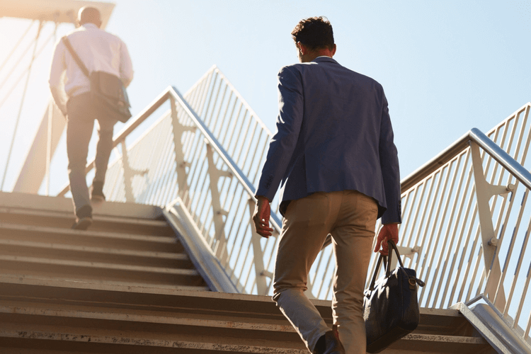 two corporate people walk up stairs